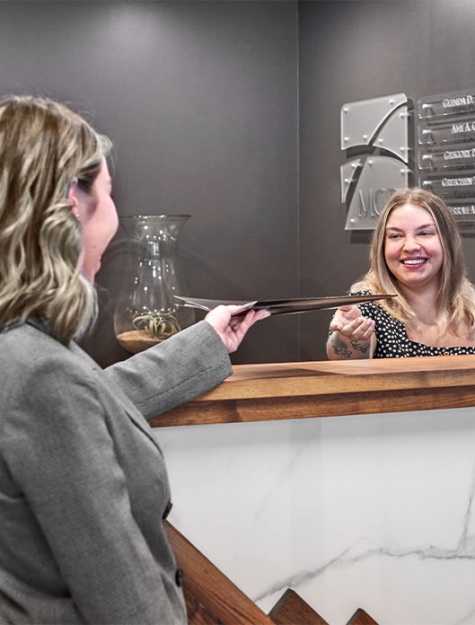 Family law practice receptionist handing a document